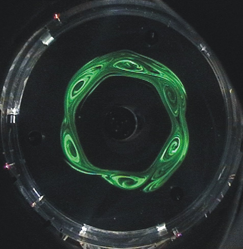 Top down view of a rotating laboratory tank showing dye tracing a hexagonal jet stream pattern, recreating the physics behind Saturn's hexagon