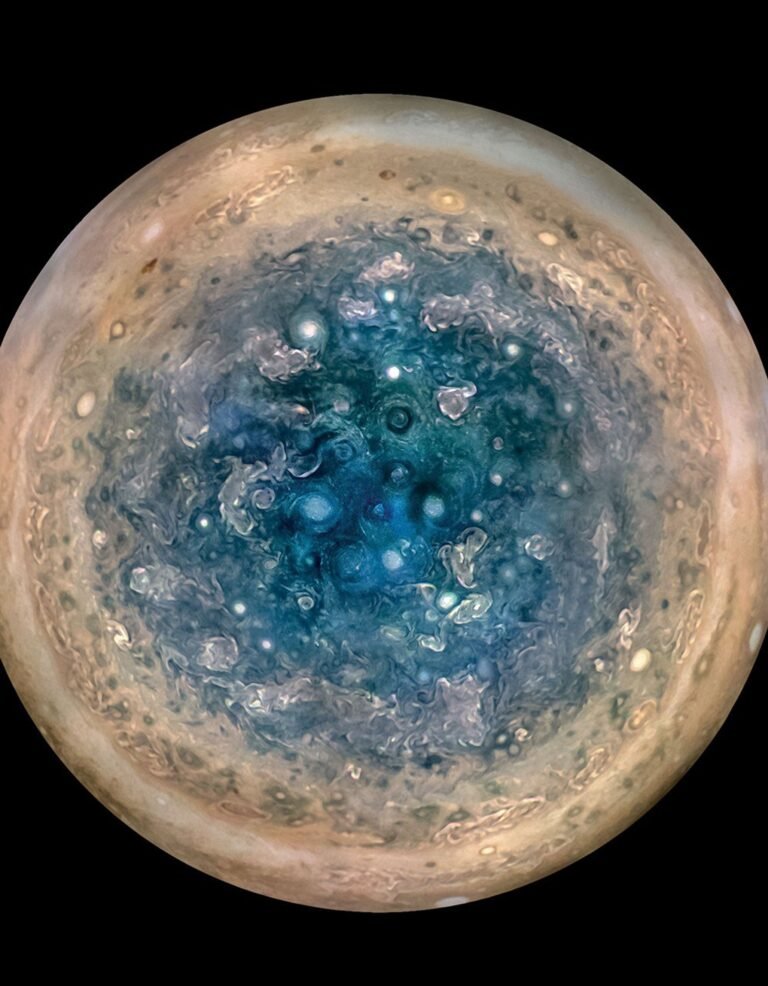 Real NASA Juno spacecraft photograph of Jupiter's south pole showing a symmetrical cluster of massive cyclones arranged around a central polar storm
